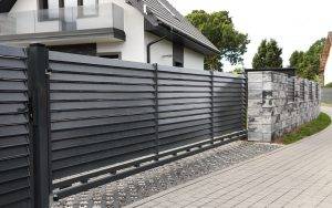 Metal Gates Near Marble Columns And House Outdoors